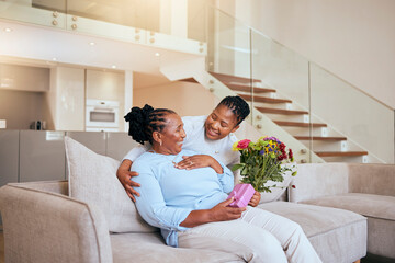 Mothers day, black woman and surprise flowers on sofa for present, box or gift to mom in living...