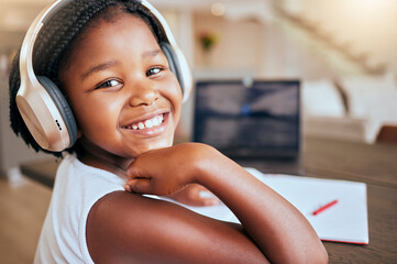 Education, homework and African girl with music for learning studying and elearning with school books in house. Podcast, happy and portrait of a young child with headphones during study for knowledge