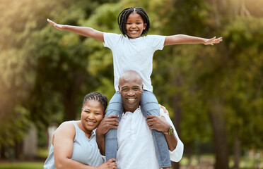 Portrait of a happy black family in nature to relax bonding in freedom, wellness and peace together in a park. Mother, father and child loves flying, hugging or playing outdoors enjoying quality time