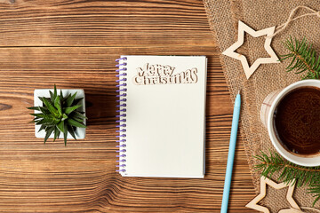 Christmas composition of open blank notepad, coffee cup, Cactus and fir branches on wooden background