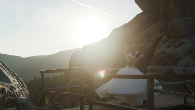 They hugging each other and feeling romantic together background cliff and rocks