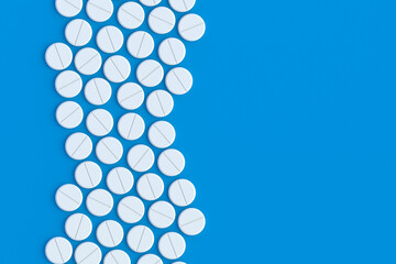Pills on blue background. Concept of healthcare and medical. Dosage of medications and vitamins. Top view. Copy space. 3d render