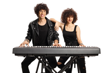 Young man and woman with curly hairs posing with a digital piano