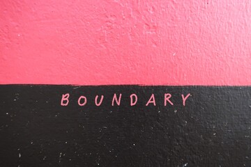 Rough pink black wall background with word BOUNDARY on border, concept of to set limit in relationship which help define what you are comfortable and would like to be treated
