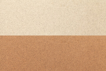 Fototapeta premium Texture of craft light beige and brown paper background, half two colors, macro. Sand vintage dense cardboard.