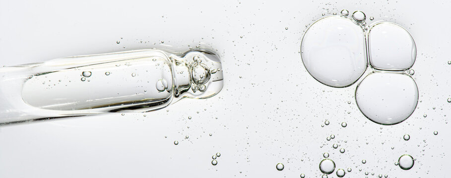 The texture of a cosmetic serum with a pipette closeup. Macrophotography