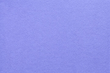 Texture of old light blue paper background, macro. Very peri color of the year 2022.