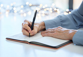 Notebook, pen and hands of old woman writing calendar schedule, checklist or business ideas in...