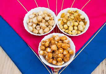 Crispy, healthy and homamade Phool Makhana or Fox Nuts snacks platter. It contain caramel makhana with jaggery, with sugar and Makhana mixture having peanut and cornflakes.