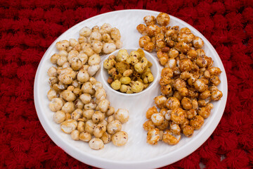 Crispy, healthy and homamade Phool Makhana or Fox Nuts snacks platter. It contain caramel makhana with jaggery, with sugar and Makhana mixture having peanut and cornflakes.