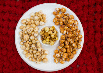 Crispy, healthy and homamade Phool Makhana or Fox Nuts snacks platter. It contain caramel makhana with jaggery, with sugar and Makhana mixture having peanut and cornflakes.