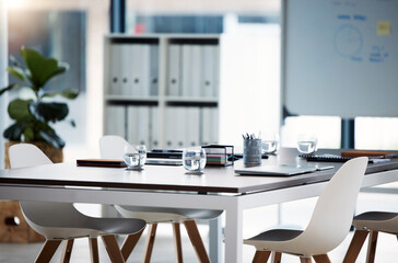 Empty meeting, conference and business room for presentation, corporate strategy discussion and training workshop. Modern chair, brainstorming and table prepared documents for collaboration boardroom
