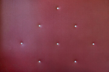 burgundy leather upholstery with metal rivets