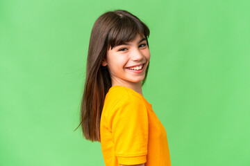 Young little brunette girl happy over isolated green background