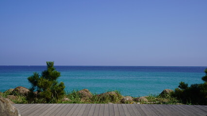 Blue sea wooden deck that waves in the blue sky