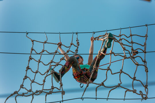 Woman hanging on the net wall