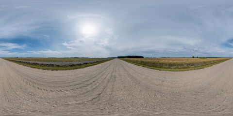 full seamless spherical hdri 360 panorama view on no traffic gravel road among fields with overcast sky and halo in equirectangular projection,can be used as replacement for sky in panoramas