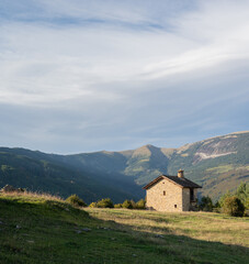 Fototapeta premium A lonely house in a mountain meadow. Calm vacation.
