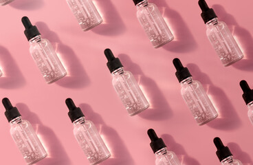 Pattern Of Transparent Glass Dropper Bottle With Serum On Pink Background. Pipette With Fluid Acid