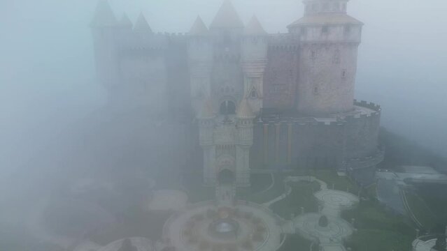 medieval castle emerging from the mist