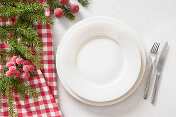 Christmas table setting with red decorative berries on white background. View from above. Copy space. Xmas dinner. Template for festive menu. - obrazy, fototapety, plakaty