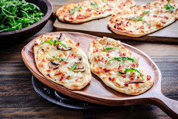 French tarte flambee with cream cheese, bacon and onions. Flammkuchen from Alsace region