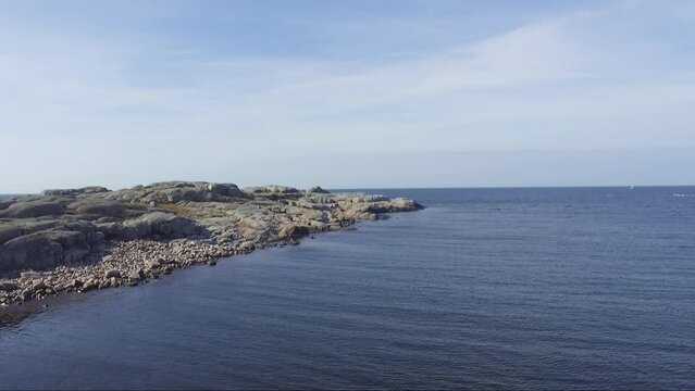 Drone shot of rock island at Gothenburg Archipelago during clear blue sky.
