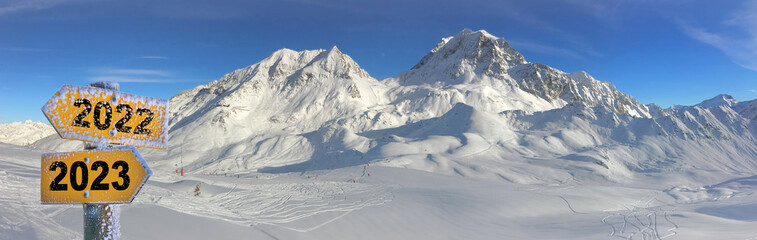 panoramic view on peak mountain covered with snow and ski tracts on th slopes