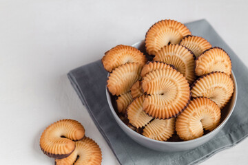 Bowl with fresh danish butter cookies on a grey napkin. Copy space.