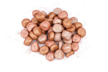 Mixed colored balls of bronzing face powder on table, bronzing pearls isolated on white background