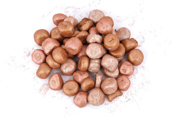 Mixed colored balls of bronzing face powder on table, bronzing pearls isolated on white background