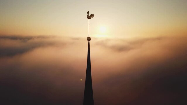 Aerial drone view through clouds on Church in old town Riga, Latvia, Europe.
