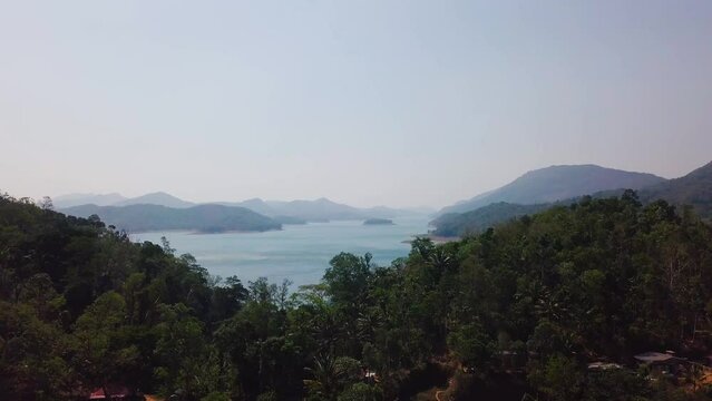 Aerial drone view of mountains, lake and forest in Kerala, Idukki