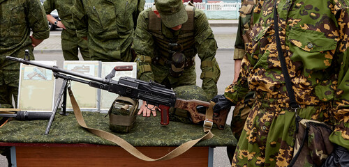 The soldiers are considering Russian made weapons.