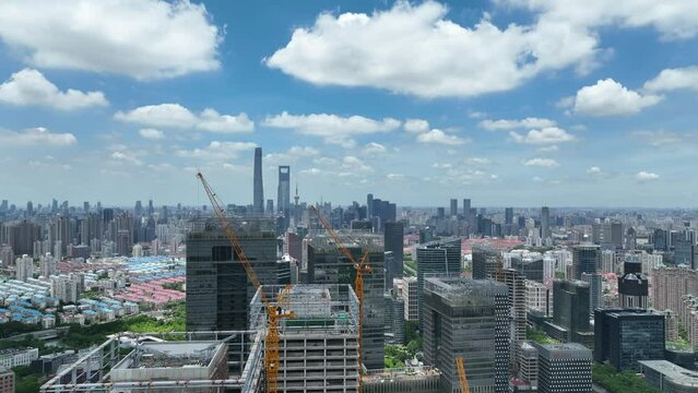 Construction site, crane and buildings in the city. Drone aerial view. Construction site in city. Cinematic cityscape Shanghai China.  Industry, business, house development concept b-roll footage.