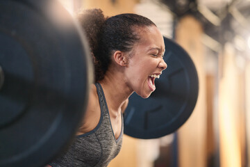 Fitness, bodybuilder and shouting with a sports black woman weightlifting in a gym for a strong body. Exercise, health and training with a female athlete shouting while lifting weights for a workout