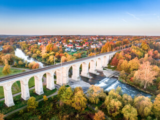 A unique autumn aerial shot of a rail bridge (wiadukt kolejowy) in Boleslawiec, Poland - obrazy, fototapety, plakaty