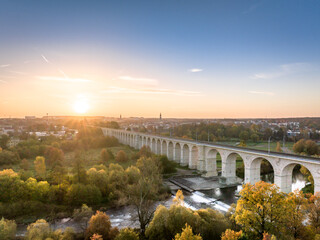 Obraz na płótnie Canvas A unique autumn aerial shot of a rail bridge (wiadukt kolejowy) in Boleslawiec, Poland at sunrise.