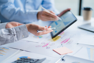 Fototapeta premium Group of business people meeting together Pointing to the graph assess business profits.