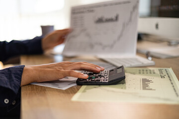 Desk with keyboard, financial reports, business sheets. Office administrator  calculates financial figures. Accounting, ordering and booking, services, back office in the industry.