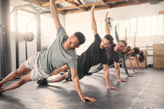 Fitness, Exercise And Training With A Sports Group Stretching Together In Gym Class For Health Or Wellness. Workout, Diversity And Coach With A Team Warmup In A Sport Facility For Performance