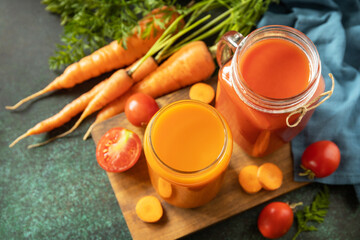 Tomato and carrot juice in a glasses and fresh tomatoes on a stone tabletop. Vitamins drinks juice...