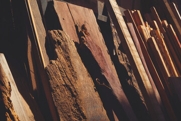 Various of the old remaining wooden material used leaning against the wall in storage room with...