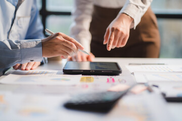 Group of business people meeting together Pointing to the graph assess business profits.