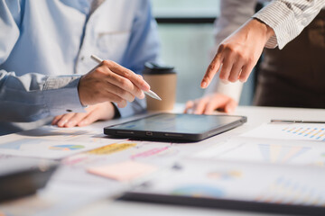 Group of business people meeting together Pointing to the graph assess business profits.