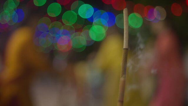 Incense stick india during navatri garba in background blurred as smoke comes out the scented stick religion and culture of indian festival