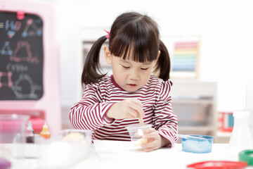 young girl playing Science experiment toys for homeschooling