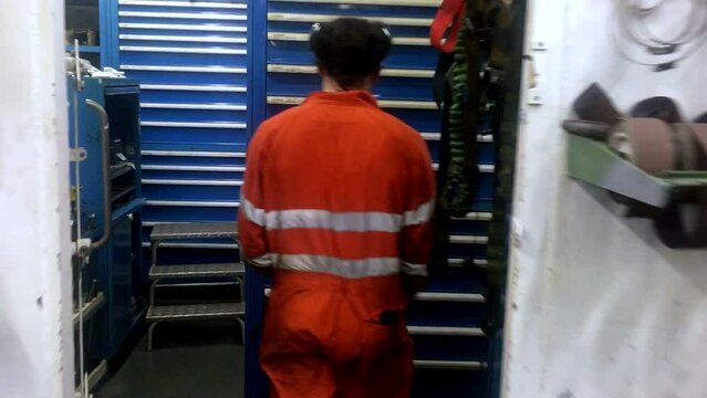 engineer walk to pick up nut and bolt draw in spare parts room