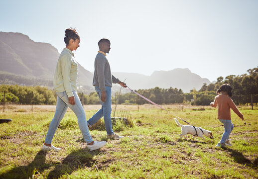 Nature, pet and black family taking a walk with dog having fun, bonding and enjoying summer. Love, animals and mom and dad walking with young girl and puppy in park on weekend, holiday and vacation