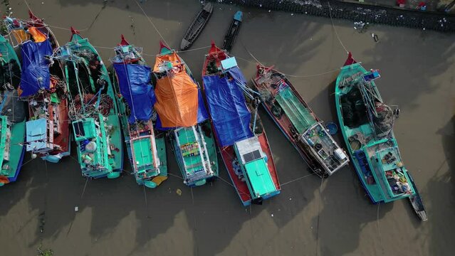 Aerial drone footage above fishermen boats in Rach Gia city, Kien Giang province, south Vietnam.  Slow slide movement from left to right 2-2